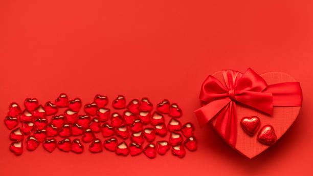 istock Valentine's Day background with red hearts, festive box and chocolates. 1363458820