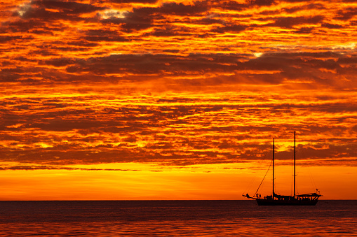 Sunset view of sail boats on the Monterey Bay, as seen from the shore of Santa Cuz.\n\nTaken in Santa Cruz, California