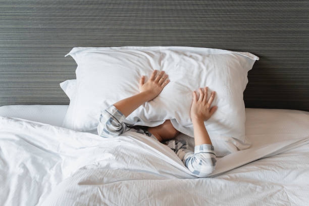 istock Lazy woman waking up from the bed. 1363460643