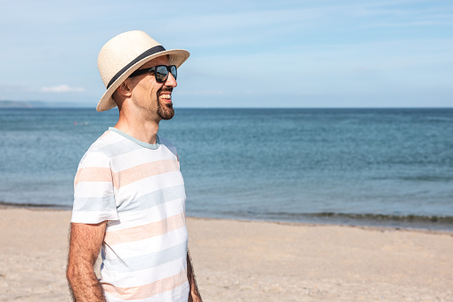 Happy man portrait at seaside in Cornwall on sunny day