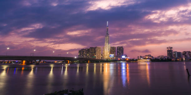 istock sunset view at Landmark 81 - it is a super tall skyscraper and Saigon bridge with development buildings along Saigon river light smooth down 1363464588