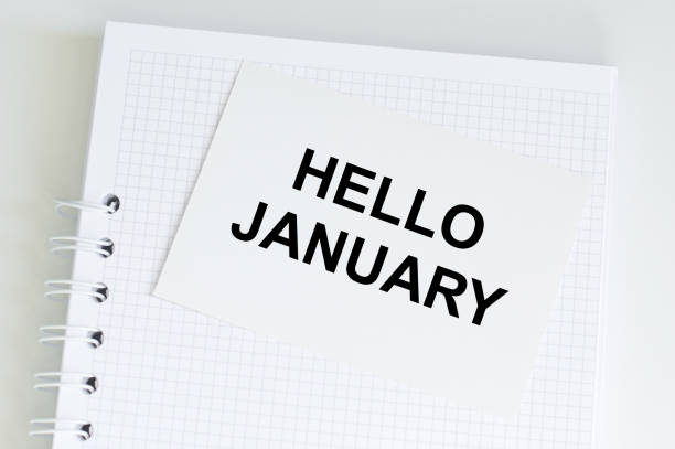 istock Hello January text on a card on the background of a notebook on the table 1363465680