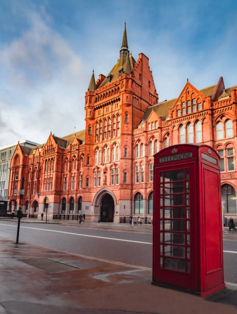 London, England, UK -  December 29, 2021: Holborn Bars, also known as the Prudential Assurance Victorian Building and a traditional red telephone booth on the street