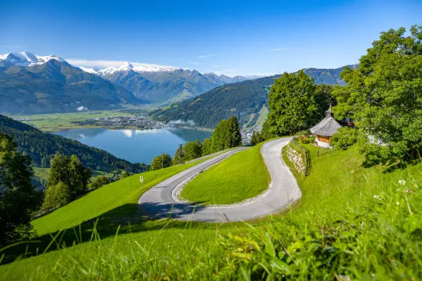 Impressive mountain road in Zell am See, in the background the Zeller See and the snow-covered Kitzsteinhorn, Salzburg, Austria, Europe