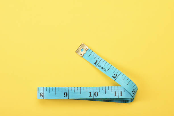 istock Tape measure on the yellow background 1363467838