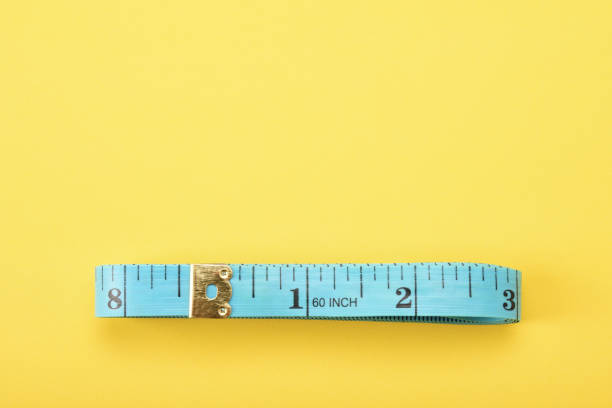istock Tape measure on the yellow background 1363467913