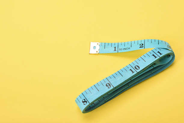istock Tape measure on the yellow background 1363467990