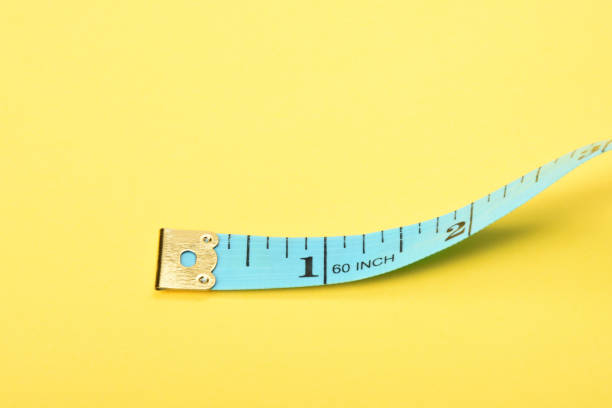 istock Tape measure on the yellow background 1363468054