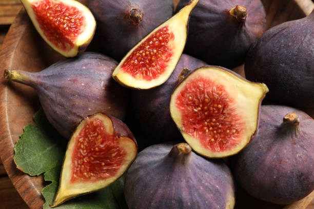 istock Whole and cut tasty fresh figs in bowl, closeup 1363469191