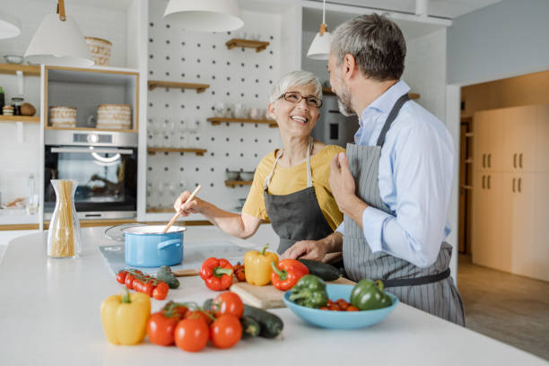 istock Mature couple preparing a meal 1363469388