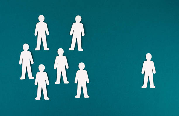 istock Group of people is standing together, one leader standing alone on the opposite side, leadership, business concept 1363469818