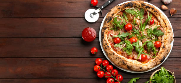 istock Tasty pizza with meat and arugula on wooden table, flat lay. Space for text 1363470531