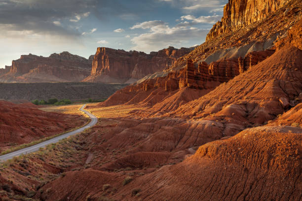 Capital Reef Cliffs and Scenic Drive at Sunset Evening clouds and winding Scenic Drive at Sunset.  Located at Capital Reef National Park in Utah. capitol reef national park stock pictures, royalty-free photos & images