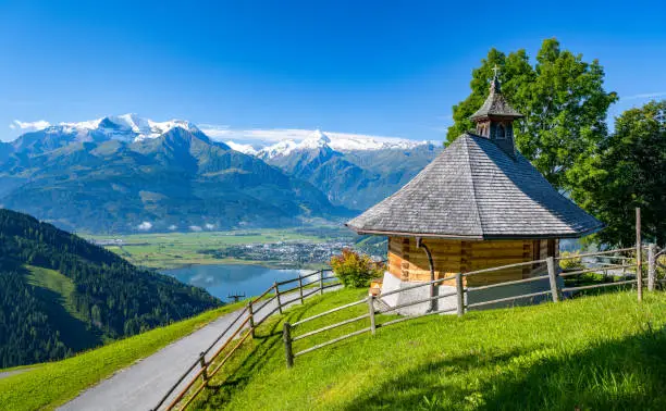 Summer mountain landscape, small mountain chapel in Zell am See, in the background the impressive snow-covered Kitzsteinhorn, Salzburg, Austria, Europe