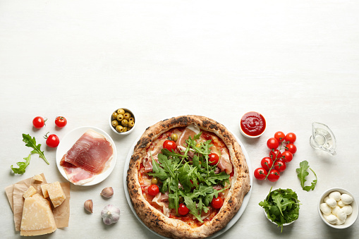 Tasty pizza with meat and arugula, flat lay. Space for text