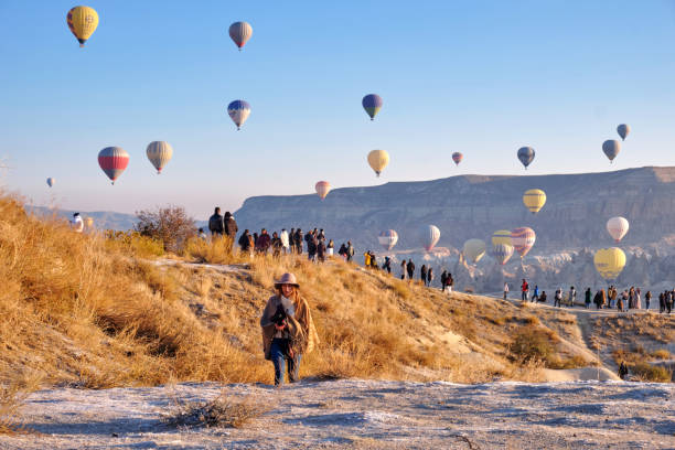 Spectators watch hot air balloons rise in Cappadocia, Turkey stock photo