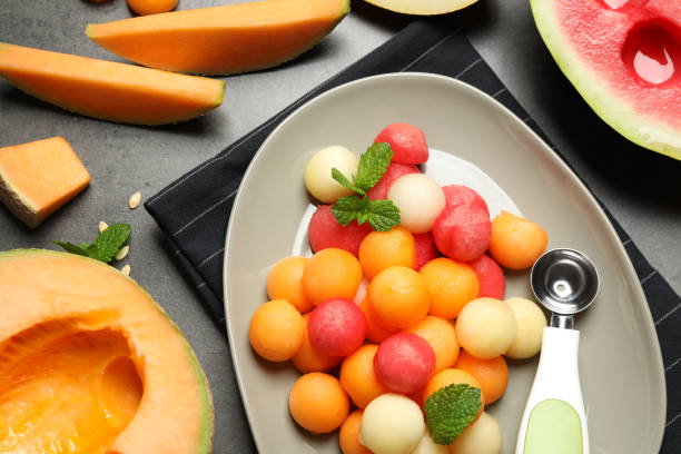 Flat lay composition with melon and watermelon balls on table Flat lay composition with melon and watermelon balls on table honeydew melon stock pictures, royalty-free photos & images