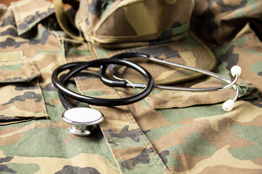 Shot of rstethoscope lies on the uniform of a US soldie. The concept of health care, military insurance, state care