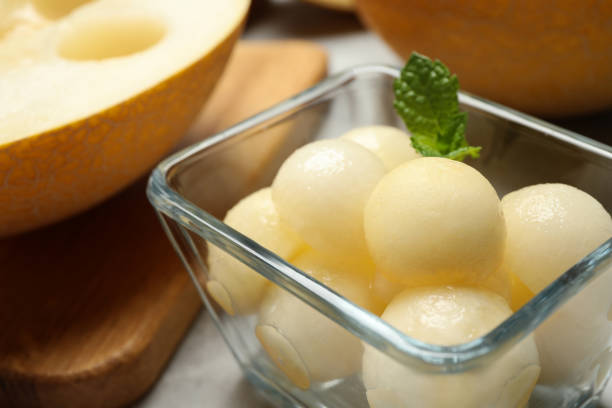 istock Melon balls with mint in glass bowl on table, closeup 1363471944