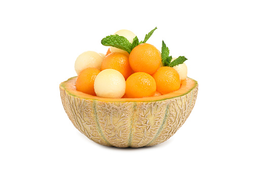 Different melon balls with mint on white background