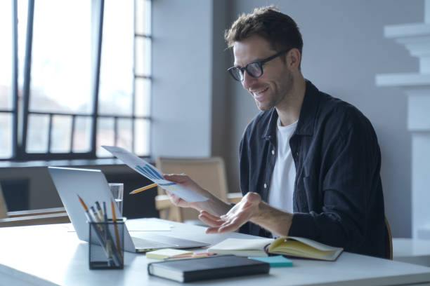 istock Young German businessman in glasses discussing calculation chart reports with partners online 1363475357