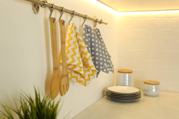Different kitchen towels hanging on hook rack indoors