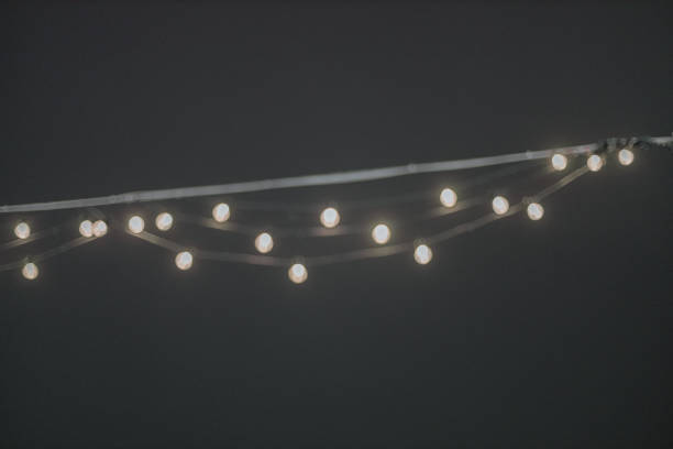 istock Garland with small led lamps shining on black background. 1363475589