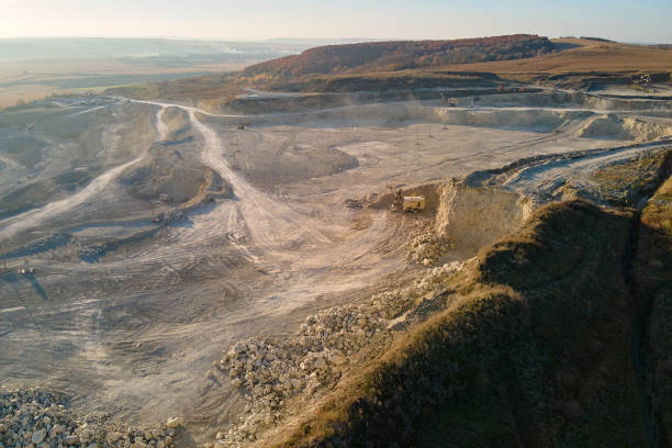 istock Aerial view of open pit mining site of limestone materials for construction industry with excavators and dump trucks 1363475668