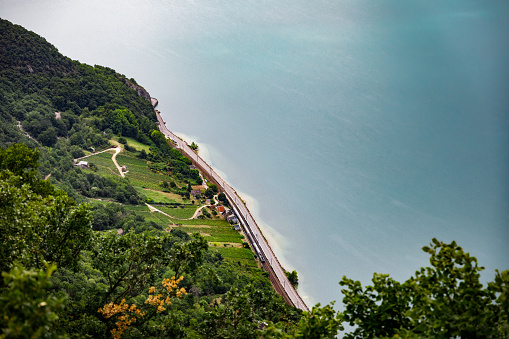 Color landscape photography of a high angle view over Bourget Lake in summer with some vineyards. This image was taken on Bourget Lake riverbanks, near Aix-Les-Bains famous thermal station city in Savoie, Auvergne-Rhone-Alpes region in France, Europe