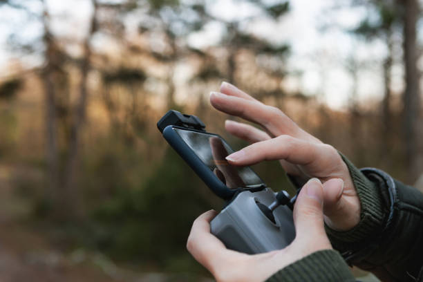 Man using remote control to operate his drone and taking photos