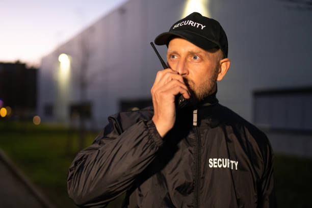 istock Security Guard Officer Using Walkie-Talkie Radio 1363479135