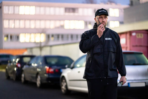 istock Car Parking Security Guard Officer Standing 1363479141
