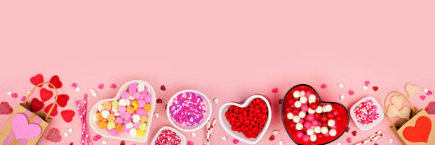 istock Valentines Day candy bottom border on a pink banner background 1363479298