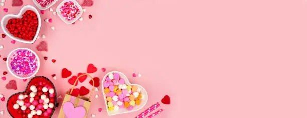 Photo of Valentines Day candy corner border on a pink banner background