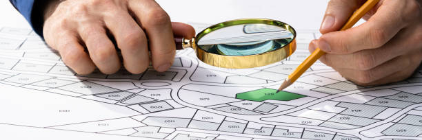 istock Human Hand Holding Pencil Over Paper Cadastre 1363480573
