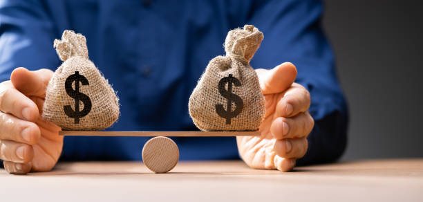 istock Money Balance On Scales 1363480609
