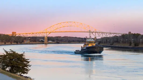 A Tugboat travels down the Cape Cod Canal at sunset