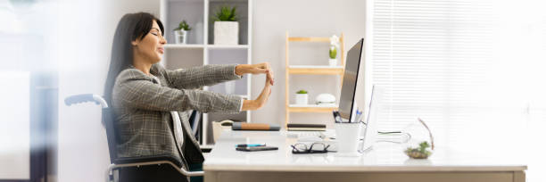 istock Woman With Disability Stretching At Desk Working 1363480832
