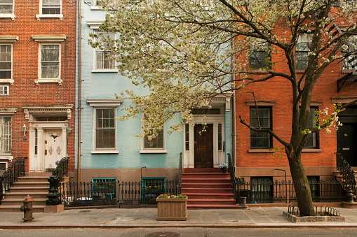 Row of townhouse buildings during springtime in West Village, New York City.