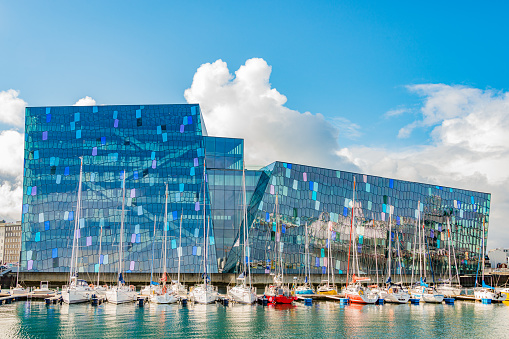 Harpa Concert Hall and Business Center at historical modern downtown in Reykjavik, at Summer in Iceland, scenic view at sunny day and blue sky