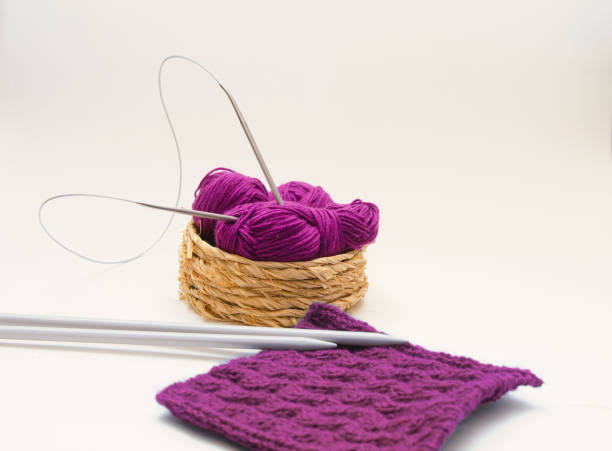 istock Balls of colored knitting threads and knitting needles on a white background 1363483026