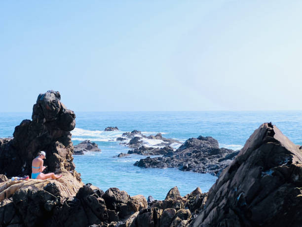 A large colony of sea lions on a rocky beach at the Ballestas Islands in Peru