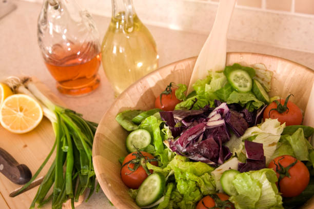 Bowl of fresh green salad on domestic kitchen counter