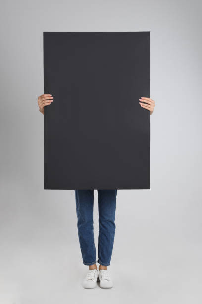 istock Woman holding blank poster on light grey background 1363489082