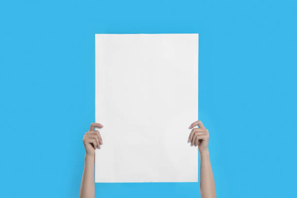 istock Woman holding blank poster on blue background, closeup 1363489092