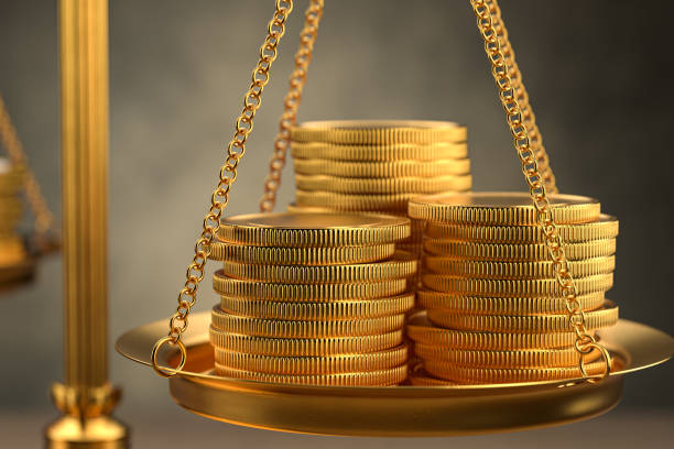 istock A stack of gold coins on the scales. Cost estimate. 3D rendering 1363490294