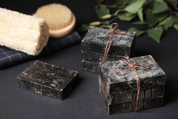 istock Natural tar soap on black table, closeup 1363490469