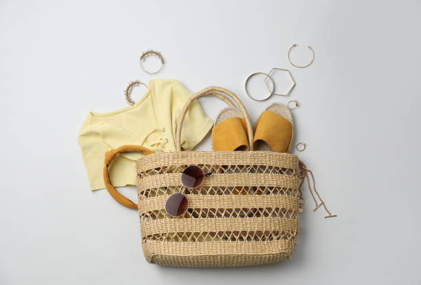 istock Stylish straw bag and summer accessories on white background, flat lay 1363491447