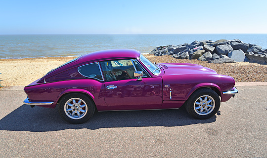 Felixstowe, Suffolk, England - May 06, 2018:  Classic Purple Triumph GT6 Parked on seafront Promenade.