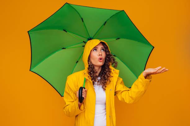 istock Girl with green umbrella 1363494833